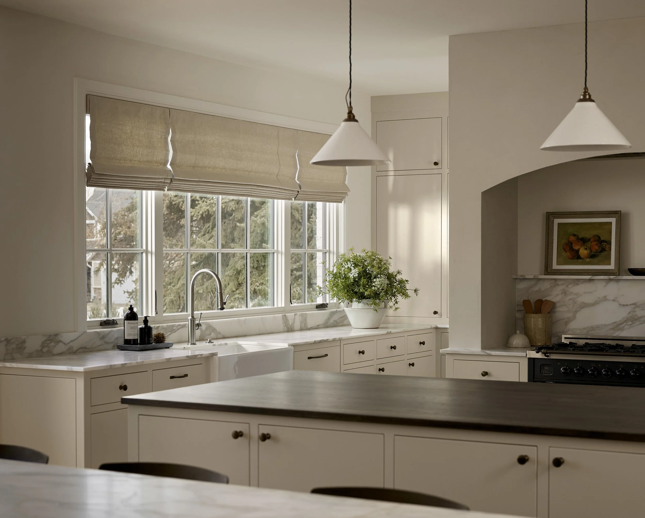 Canyon Cove kitchen with walnut cabinetry, Calacatta marble countertops, and plaster range hood