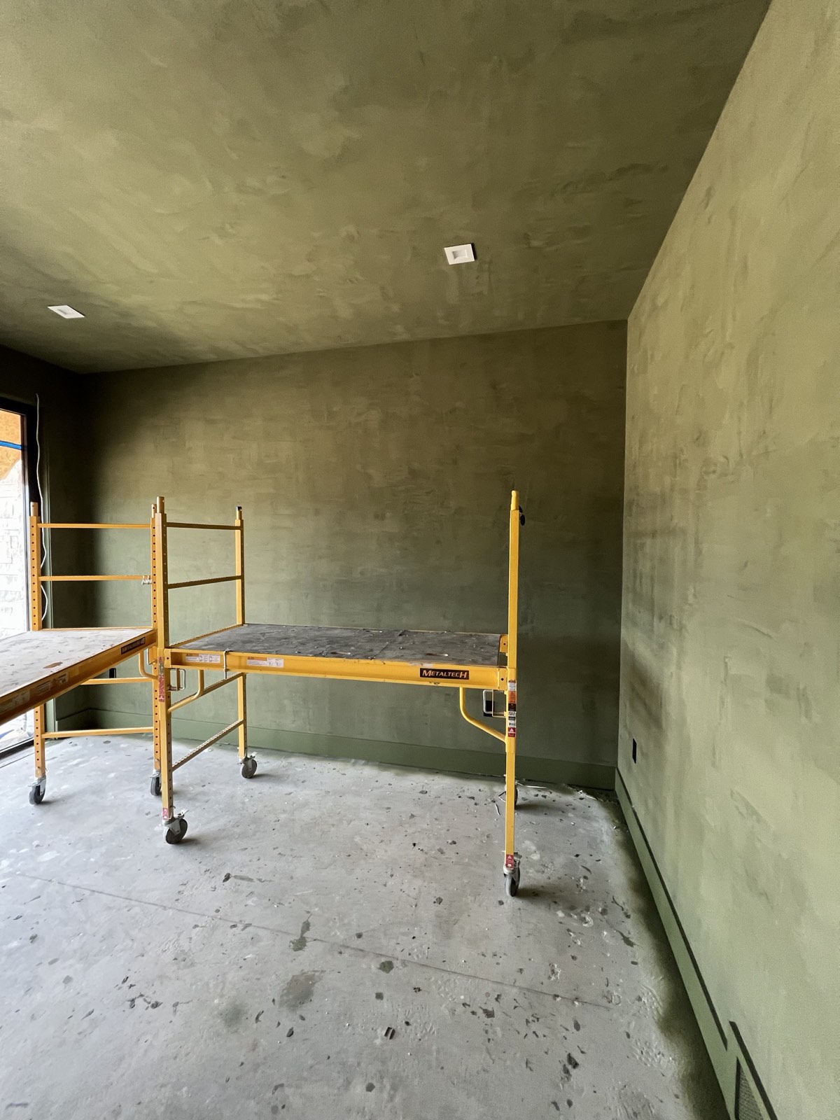 Guest room with olive Roman Clay on the walls and ceiling, scaffolding still up