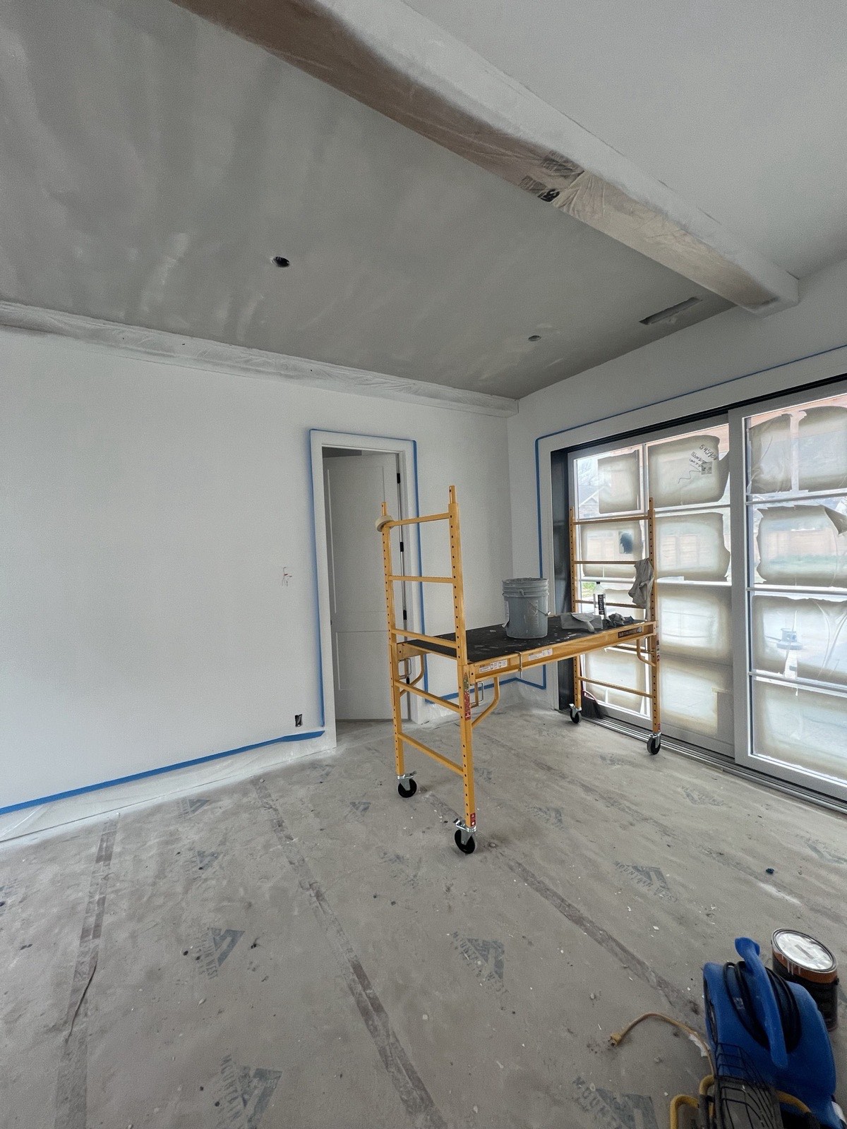 Pool house main room before plaster, with scaffolding and floor protection